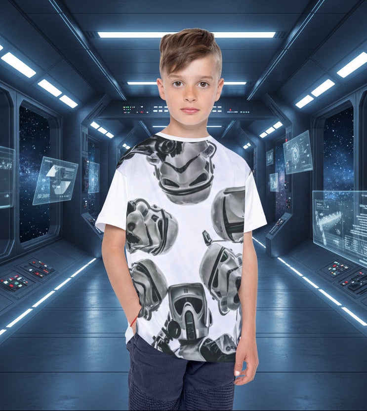 Child wearing a white t-shirt with black graphic designs on a white background