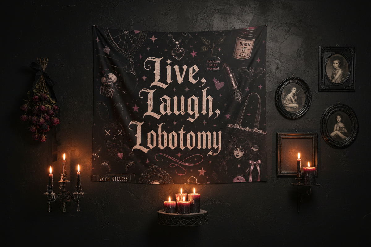 A gothic-themed wall tapestry featuring the text 'Live, Laugh, Lobotomy' in a distressed white font, surrounded by dark illustrations including a skeleton, a bottle labeled 'Burn It All', a syringe, and small pink stars and hearts on a black background.